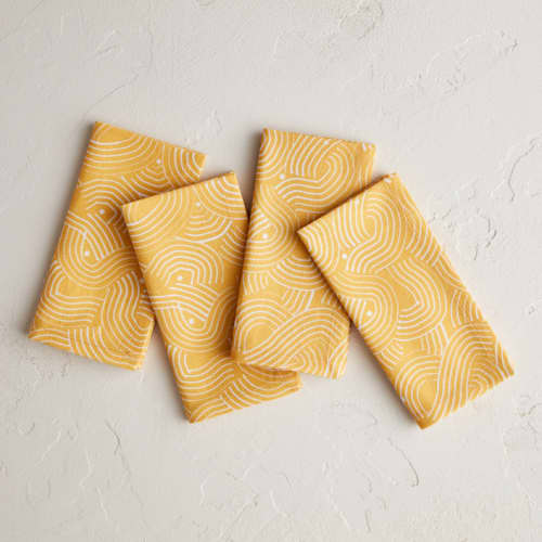 This is a golden table linens by Lise Gulassa called sunshine wave in standard
