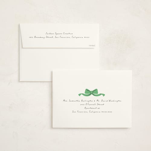 This is a greenery holiday photo cards with standard by mo kelley called wreath with bow printing on signature in grand