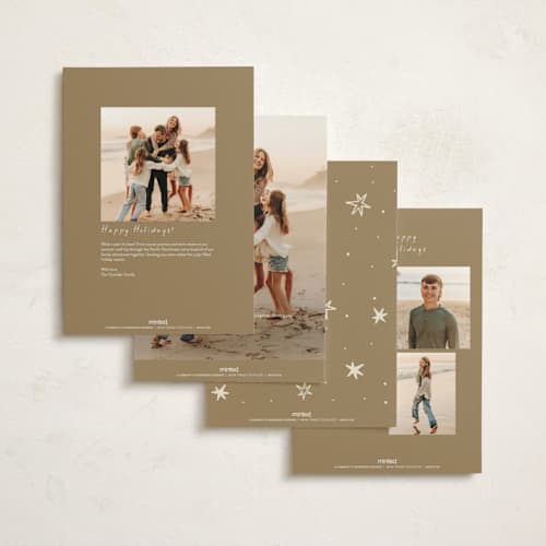 This is a champagne holiday photo cards with standard by Ani Somi called a very merry holiday cheers printing on signature in grand