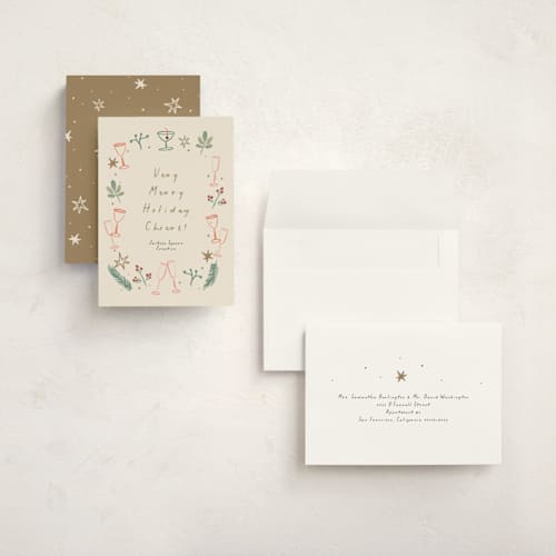 This is a champagne holiday photo cards with standard by Ani Somi called a very merry holiday cheers printing on signature in grand