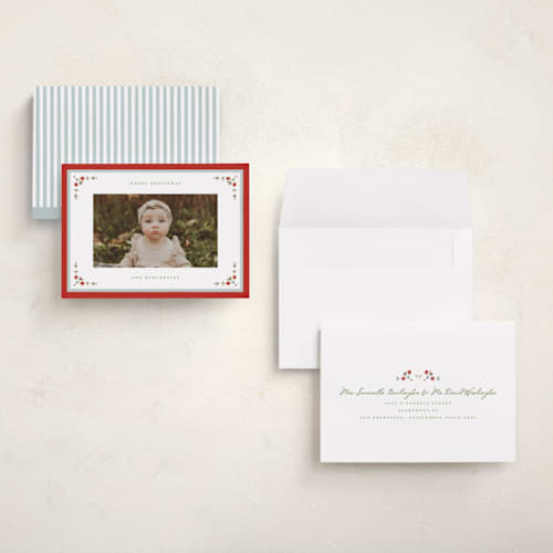 This is a holly berry holiday photo cards with standard by Wildfield Paper Co called laurel border printing on signature in grand