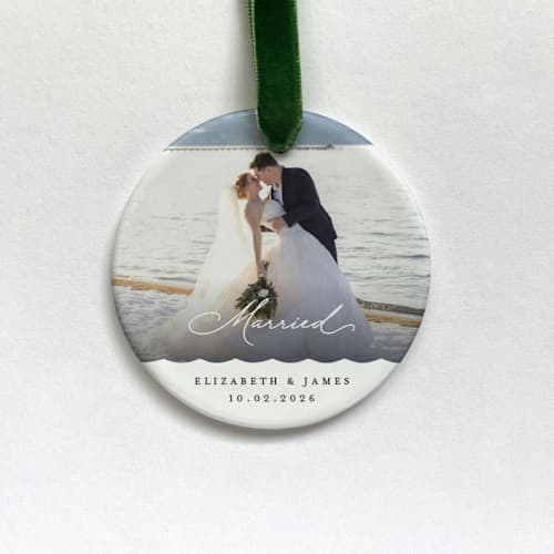 This is a white holiday decorations by Holly Whitcomb called personalized married photo ornament in standard