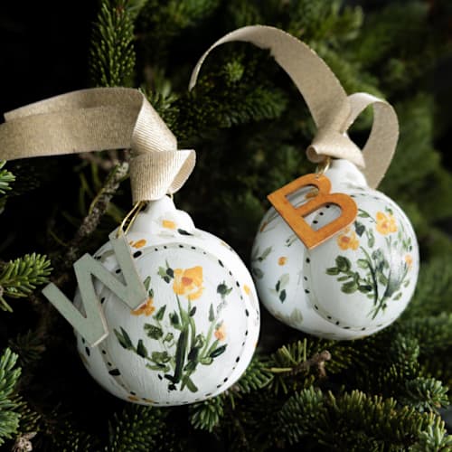 This is a multicolorassorted-colors holiday decorations by Lottie Aldarwish called set of 2 green and indian yellow floral customized ornaments in standard