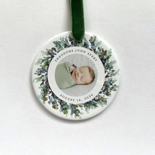 This is a white holiday decorations by Holly Whitcomb called personalized baby photo ornament, painted wreath in standard