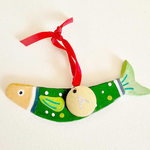 This is a green holiday decorations by AlisonJerry called personalized, hand made green clay sardine ornament in standard