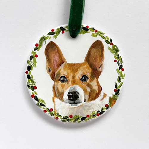 This is a white holiday decorations by Holly Whitcomb called hand-painted pet portrait ornament with wreath border in standard