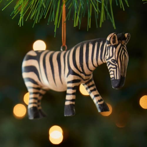 This is a black holiday decorations by Aahlada Chennupati called painted wood zebra christmas ornament in standard
