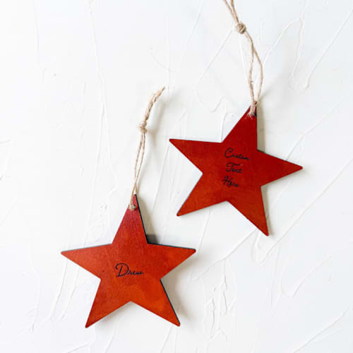 This is a brown holiday decorations by Left Grain called personalized leather star ornament in standard