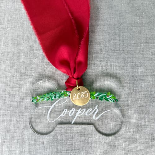 This is a clear holiday decorations by Orchid Studio called dog bone custom christmas ornament in standard