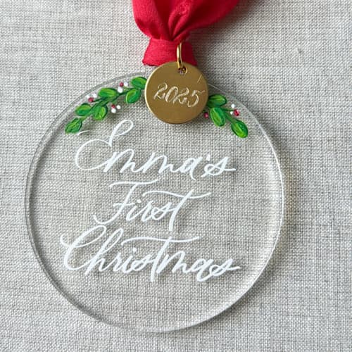 This is a clear holiday decorations by Orchid Studio called baby first christmas custom round ornament in standard