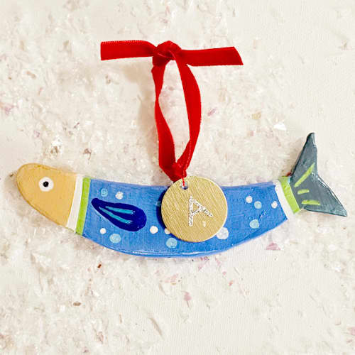 This is a green holiday decorations by AlisonJerry called personalized, hand-made clay blue sardine ornament in standard