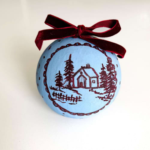 This is a blue holiday decorations by Arohika Verma called hand-painted winter cottage ornament in standard