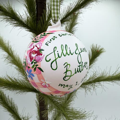 This is a pink holiday decorations by Ashley Myers called personalized floral gingham first christmas ornament in standard