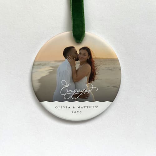 This is a white holiday decorations by Holly Whitcomb called personalized engagement photo ornament in standard