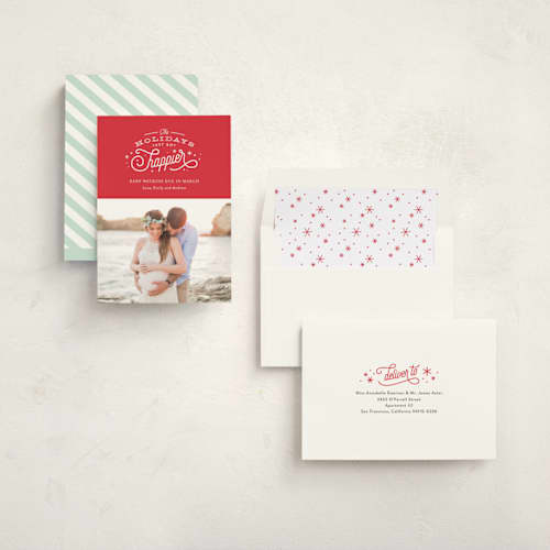 This is a poinsettia pregnancy announcements with standard by Jennifer Wick called happier holidays printing on signature in standard