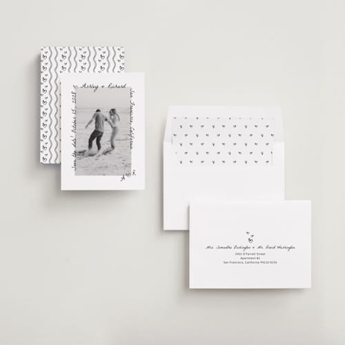 This is a graphite foil stamped save the date cards with foil pressed by Claudia Orengo called showered printing on recycled smooth signature in standard