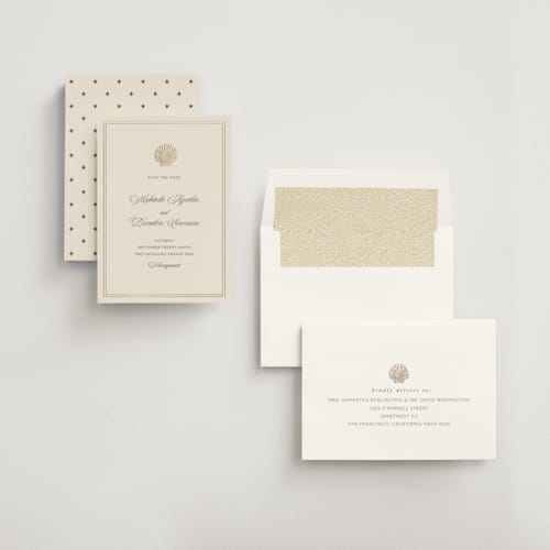 This is a champagne foil stamped save the date cards with foil pressed by Griffinbell Paper Co. called seaside printing on signature in standard