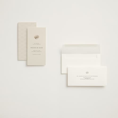 This is a sand foil stamped save the date cards with foil pressed by Hannah Bowman called simple seashell printing on signature in tall