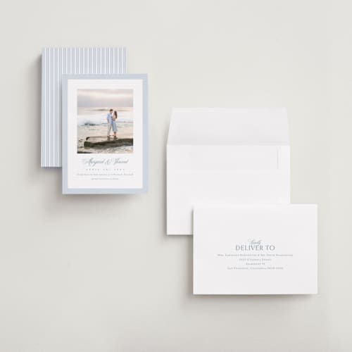 This is a dusty blue save the date with standard by Jennifer Postorino called coastal charm printing on recycled smooth signature in grand