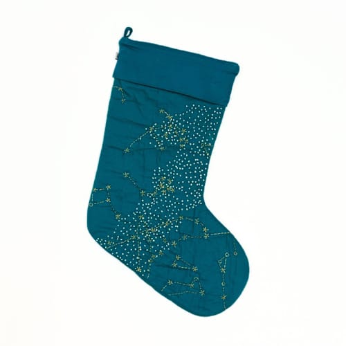 This is a green holiday decorations by Haptic Lab called teal constellation stocking in standard