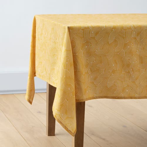 This is a golden table linens by Lise Gulassa called sunshine wave in standard