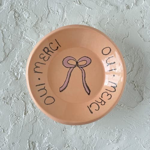 This is a orange decorative objects by Quiet Clementine called french bow round trinket dish in standard