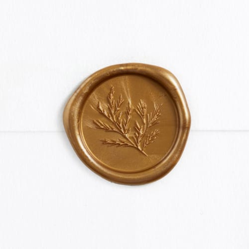 This is a antique gold wax seals by Rebecca Durflinger called pine sprig in gold (pack of 25) in standard