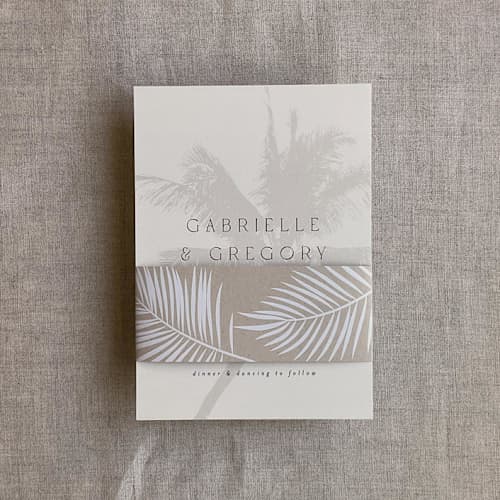 This is a beige belly bands by Ivory Invitations called palm leaf taupe brown belly band for 5x7 card | pack of 10 in standard