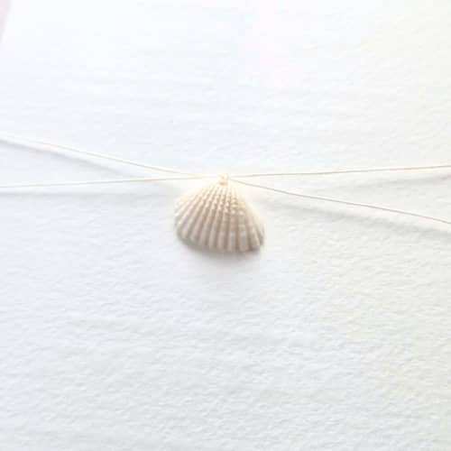 This is a multicolor belly bands by Inkspiringletters called linen thread and seashell belly band- customizable thread color- set of 25 in standard