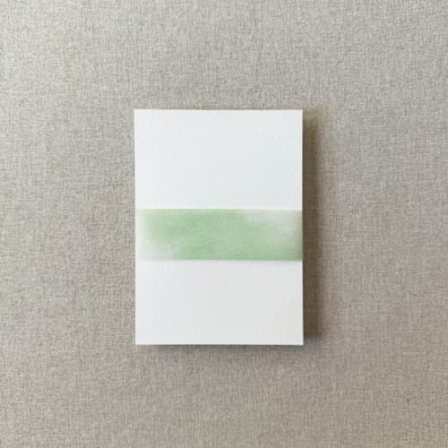 This is a green belly bands by Cotton and Bow called green watercolor vellum belly band | for 5x7" invitations | set of 10 in standard