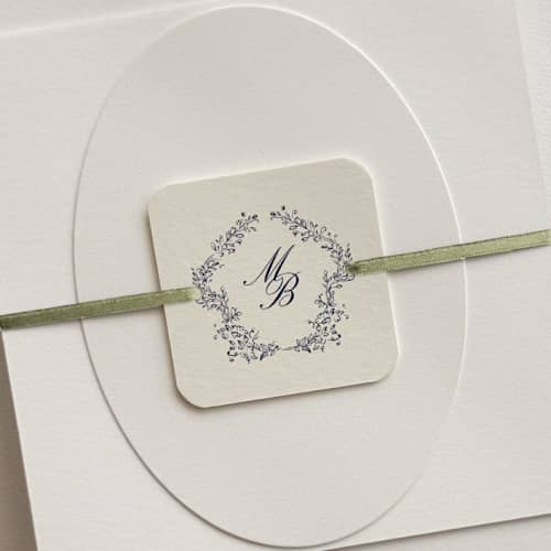 This is a multicolorassorted-colors belly bands by Paper Haven called customizable monogram wreath bellyband tags with ribbon for 5 x 7 invitation | pack of 25 in standard