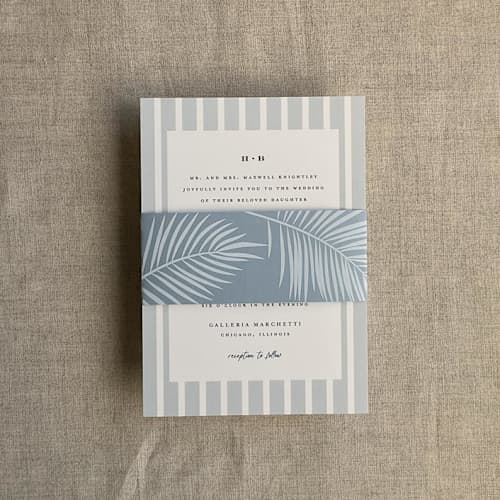 This is a blue belly bands by Ivory Invitations called palm leaf steel blue belly band for 5x7 card | pack of 10 in standard