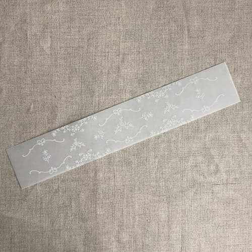 This is a white belly bands by Ivory Invitations called grace floral white vellum belly band for 5x7 card | pack of 10 in standard