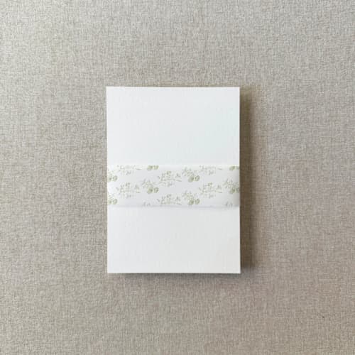 This is a green belly bands by Cotton and Bow called sage toile vellum belly band | for 5x7" invitations | set of 10 in standard