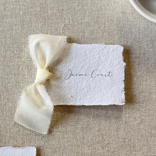 This is a white wedding favor tags by Cotton and Bow called handmade paper tag with ivory bow | set of 10 | custom text in standard