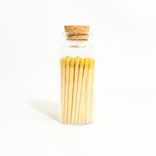 This is a gold matchbooks by Summer Hedglin called gold matchsticks in medium corked vial in standard