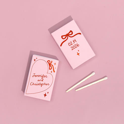 This is a pink matchbooks by ForYourParty called hand-drawn heart & bow matchboxes, set of 100 in standard