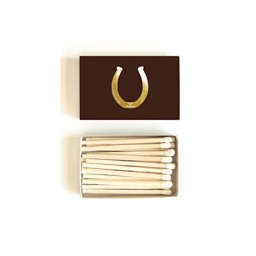 This is a brown matchbooks by Jessica Cunningham called lucky horseshoe matchbox, gold on brown in standard