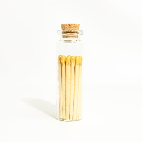 This is a gold matchbooks by Summer Hedglin called gold matchsticks in small corked vial in standard