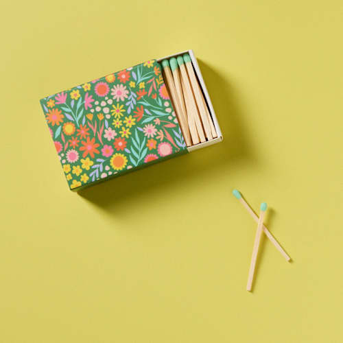 This is a green matchbooks by Summer Hedglin called floral meadow matchbox with colorful matchsticks in standard
