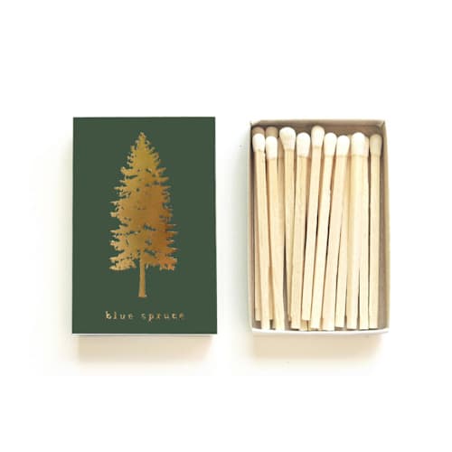 This is a green matchbooks by Jessica Cunningham called blue spruce tree matchbox, gold on evergreen in standard