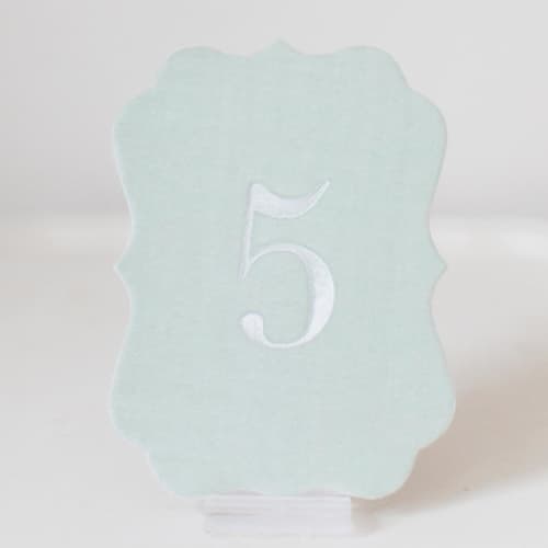 This is a pink table numbers by Velvet Raptor called scroll table number - sea green in standard