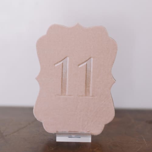 This is a pink table numbers by Velvet Raptor called double sided table number - scroll - blush in standard