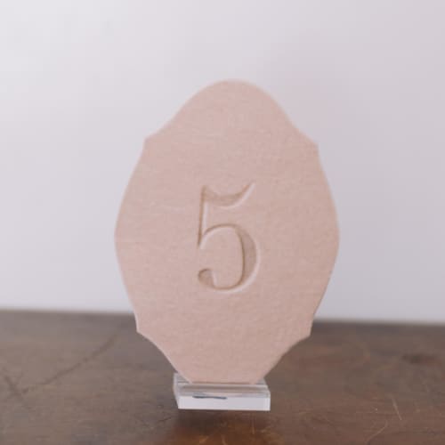 This is a pink table numbers by Velvet Raptor called double sided table number - oval - blush in standard