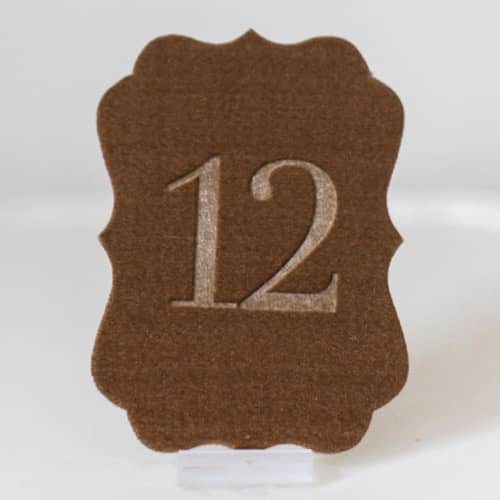 This is a gold table numbers by Velvet Raptor called gold scroll table number in standard