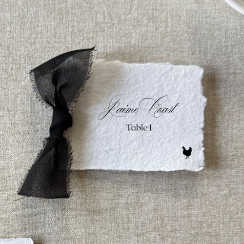 This is a black wedding place cards by Cotton and Bow called handmade paper place cards with black bow | set of 10 | custom text in standard