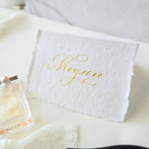 This is a white wedding place cards by Inkspiringletters called custom calligraphy place cards- tent- style handmade paper- set of 10 in standard