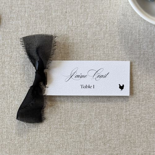 This is a black wedding place cards by Cotton and Bow called slim place cards with black bow | set of 10 | custom text in standard