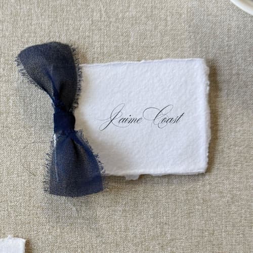This is a blue wedding place cards by Cotton and Bow called handmade paper place cards with navy bow | set of 10 | custom text in standard