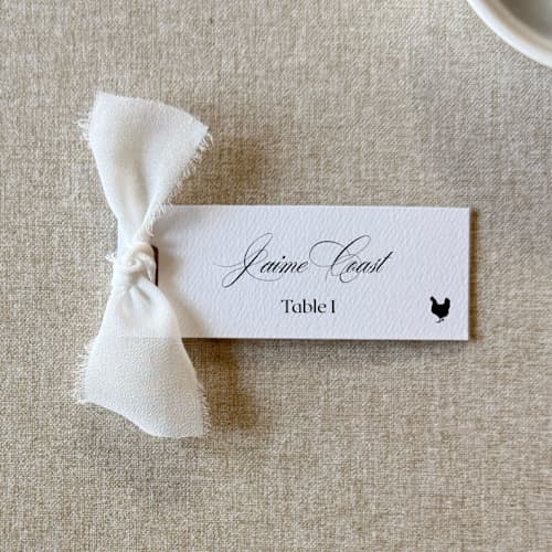 This is a white wedding place cards by Cotton and Bow called slim place cards with white bow | set of 10 | custom text in standard